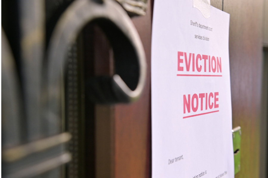 A sign posted on a door reads "Eviction Notice" in large red letters.